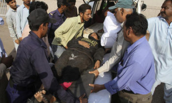 People transfer an injured train passenger to a hospital in Karachi, Pakistan, Thursday, Nov. 3, 2016. A passenger train crashed into the back end of another in Pakistan's southern port city of Karachi on Thursday, killing many people and injuring others, officials said. (AP Photo/Fareed Khan)